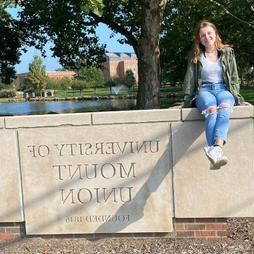 gracyn sage sitting on mount union sign